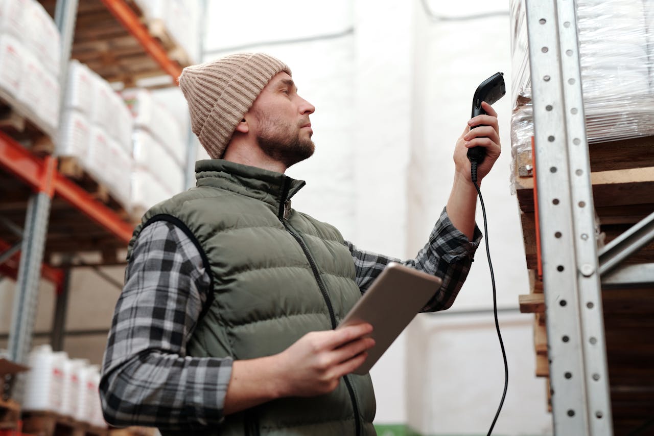 The Art of Drawing Readers In: Your attractive post title goes here Male warehouse staff scanning inventory with handheld scanner and tablet indoors.